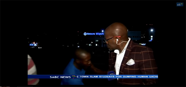 (South Africa’s Broadcasting Corporation crew being robbed on live TV. Photo: Youtube)...