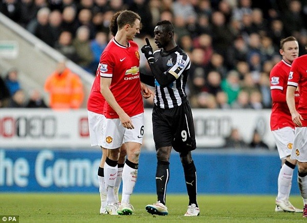 The Senegalese striker (right) points the finger at United's defender after the incident