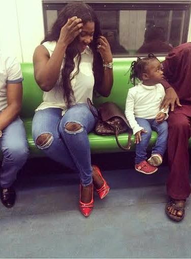 (Mercy Johnson and her daughter board a train in Lagos. Photo: Big Sam)