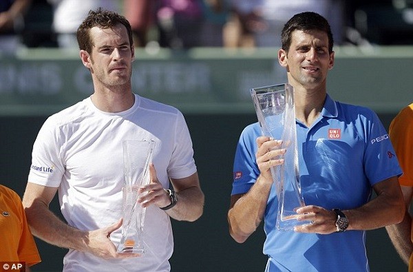 A deflated Murray holds his runners-up trophy alongside Djokovic after the pair battle the heat of Florida