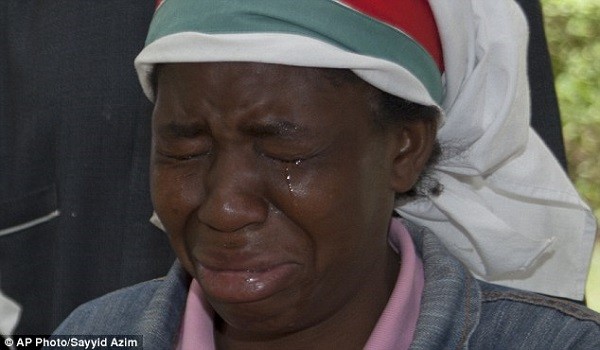 A relative of one of the students who was murdered weeps