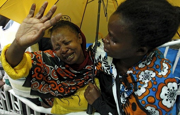 A woman reacts after seeing her son who was rescued from the Garissa University College attack