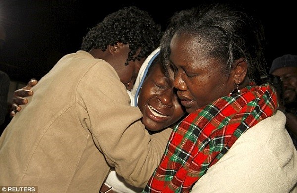 A woman who survived the attack (centre) is reunited with relatives at Nyayo stadium in Nairobi today