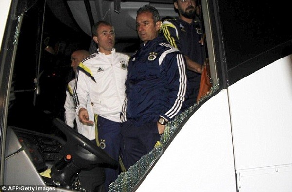 Ashen-faced head coach Ismail Kartal surveys the damage to the team bus