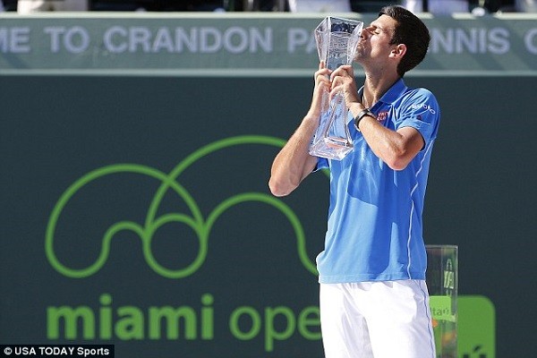 Djokovic kisses his fifth Miami Open winner's trophy after an emphatic finish to the match on Sunday