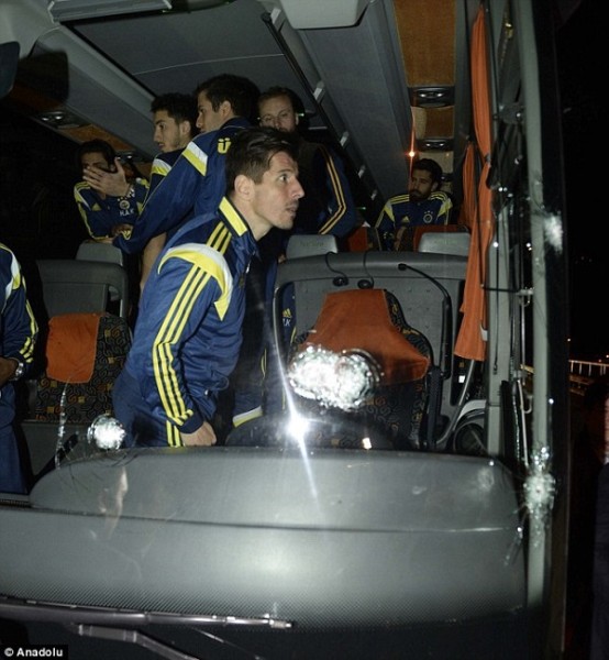 Five round marks can be seen on the windscreen of the Fenerbahce team bus after the attack