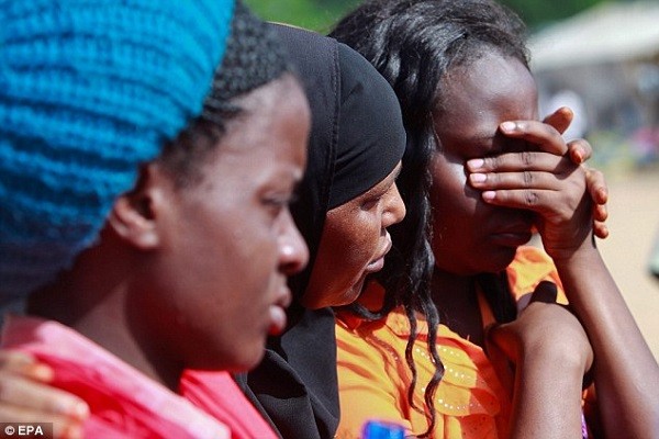 Garissa University College students are comforted as they come to terms with Thursday's masssacre