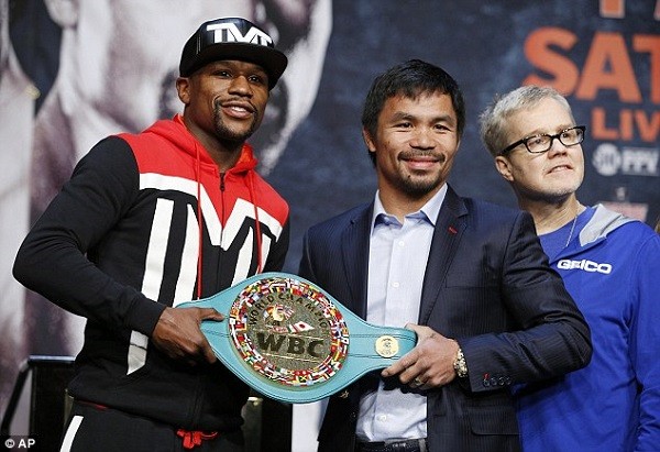 Mayweather and Pacquiao with the WBC welterweight belt which contains 3,000 emeralds
