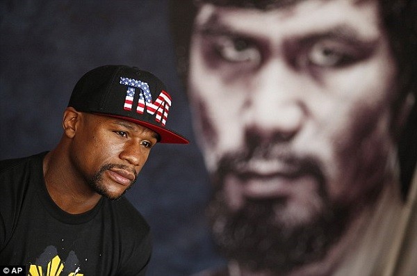 Mayweather speaks to the media with the giant figure of Pacquiao looming in the background