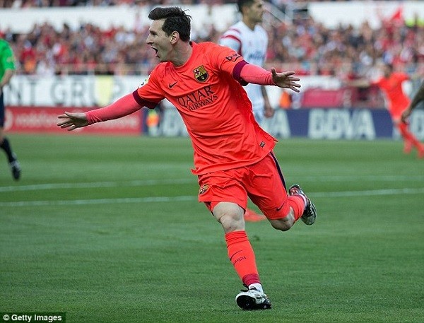 Lionel Messi poses with each of the 32 balls he has taken home after scoring a hat-trick for Barcelona
