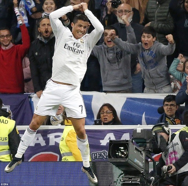 Ronaldo celebrates after securing the 3-1 victory late on after Malaga had pulled one back
