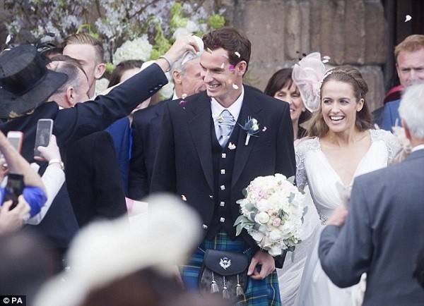 The happy couple are covered in confetti as they make their way out of the wedding ceremony