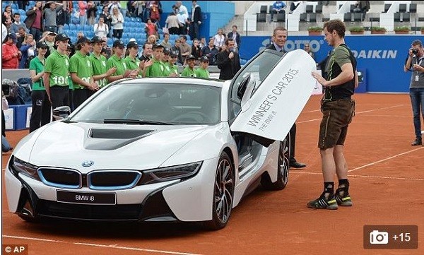 Andy Murray inspects his new car after winning the Munich final against Germany's Philipp Kohlschreiber