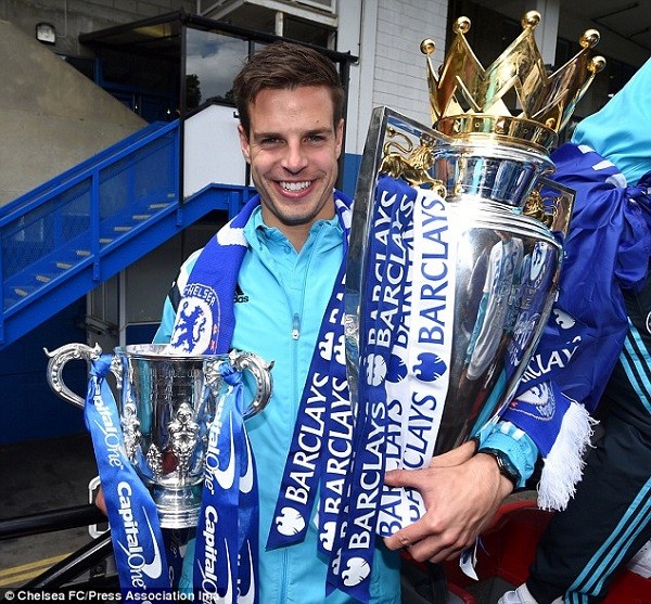 Blues full back Azpilicueta holds up both the Capital One Cup and Premier League trophy during the parade