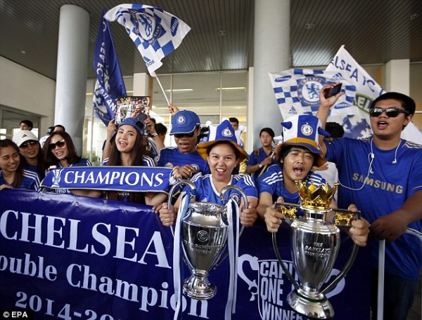 Chelsea supporters in Thailand held up replica trophies as their team arrived for their friendly on Saturday