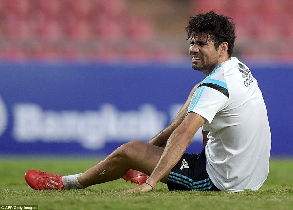 Costa grimaces on the turf after suffering a problem with his right foot following John Obi Mikel's challenge at the Rajamangala Stadium
