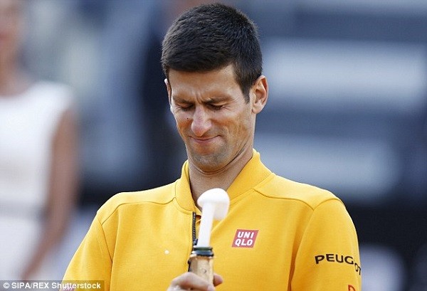 Djokovic's attempt to open the champagne bottle went awry, however, when he hit himself in the face with the popping cork