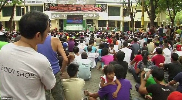 Fans flocked to gather round any screen they could find - in this case one on the side of a lorry