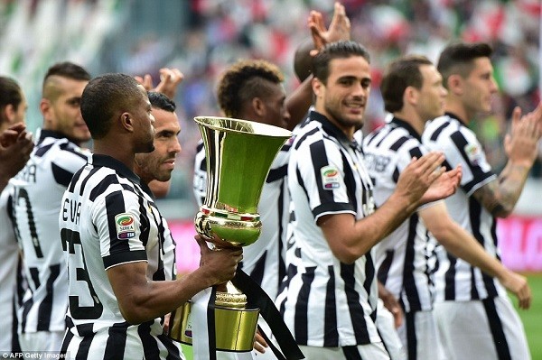 French defender Patrice Evra holds the Italian Cup as the Juventus squad parade the piece of silverware before ahead of kick-off