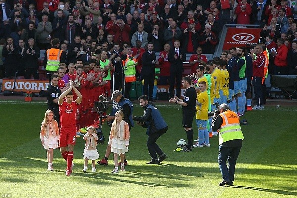 Liverpool captain Steven Gerrard applauds the supporters as he is greeted by a guard of honour before his final match at Anfield