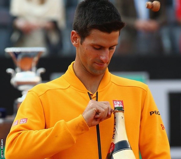 Novak Djokovic lifts the Italian Open trophy after retaining his title in straight sets