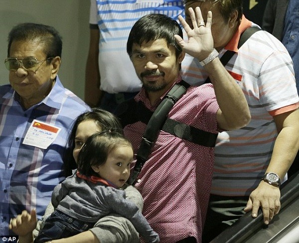 Pacquiao was greeted by his wife Jinkee and youngest son Israel (bottom left) after landing in Manila