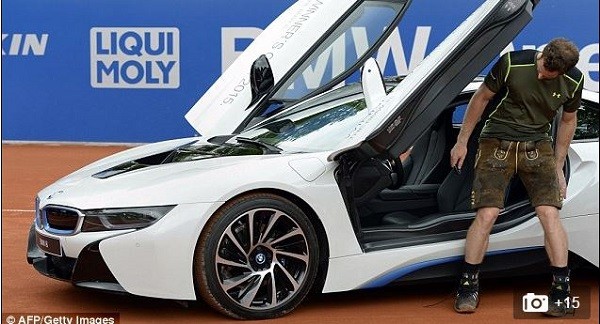 The Scot takes a seat in the winner's car, a BMW i8, still dressed in his new Bavarian Lederhosen