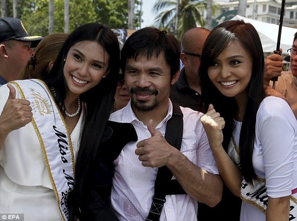 The boxer poses for a photograph after arriving back home in the Philippines in Asia