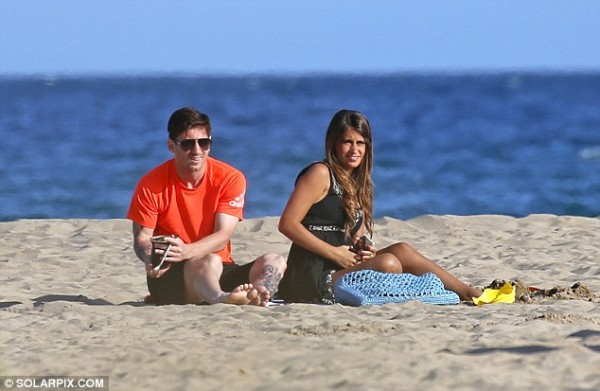 The couple looked on as their son Thiago played in the sand nearby as Messi prepares for two cup finals
