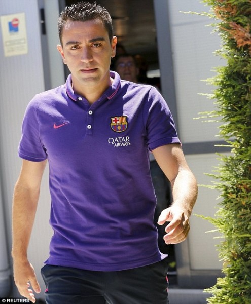 Xavi leaves a press conference after telling the media he would leave Barcelona at the end of the season