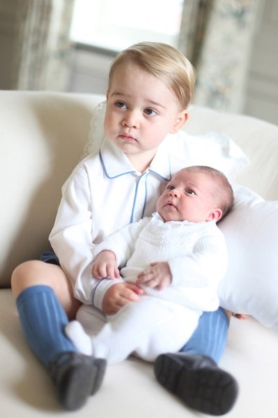 Prince George cradles his baby sister, Princess Charlotte