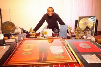 Youssou N'Dour shows off his collection of awards. Photo: N'dour