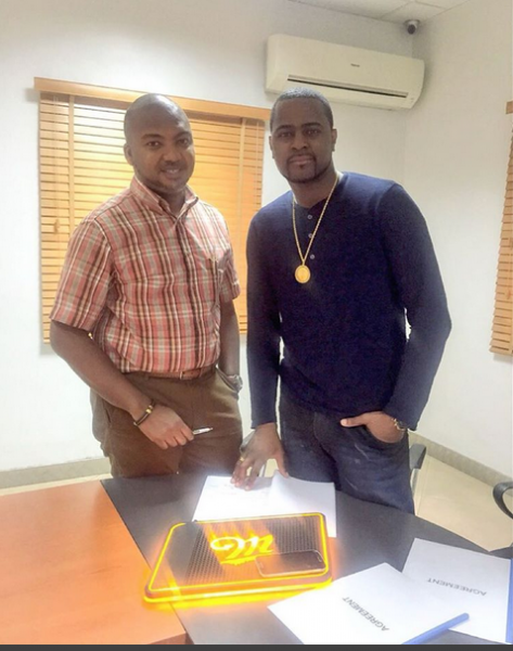 (Dj Xclusiv signing the deal to become a Miller brand ambassador)