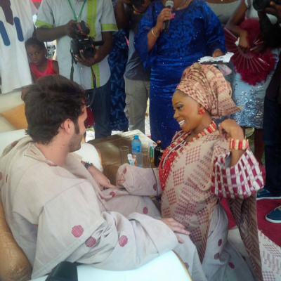 (Tosyn Bucknor kneels before her boo at their traditional wedding)