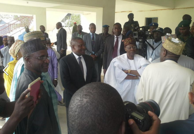 Aliko Dangote and Lai Mohammed wecomes Buhari at the helipad in Kaduna