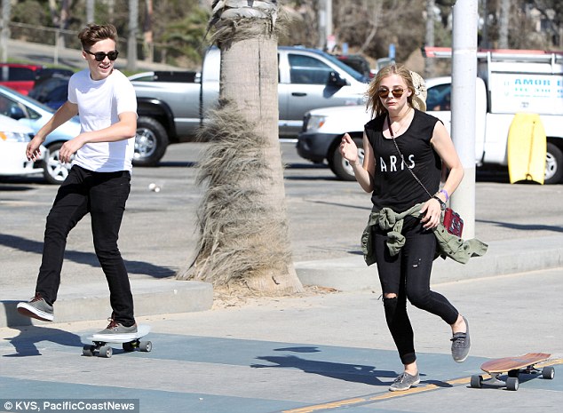 Chloe Moretz and Brooklyn Beckham ride skateboards by the beach in Santa Monica.