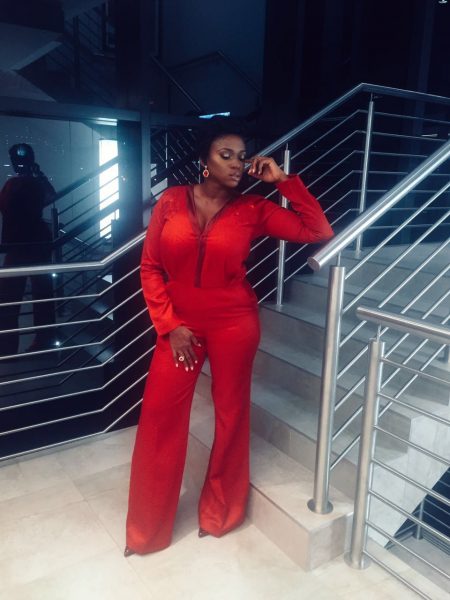 Waje dazzled in in a red Samuel Noon jumpsuit