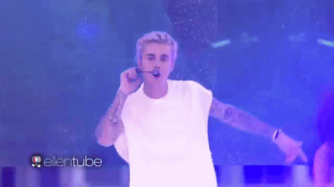 Bieber performing onstage at his 2015 outdoor concert .