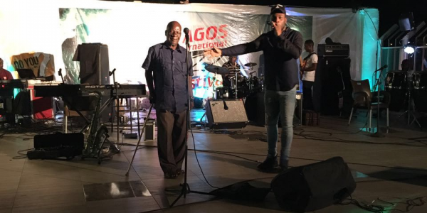 Burna Boy on stage with his grand-father.