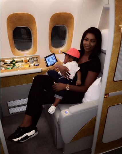 Tiwa savage and her son on a plane to Dubai.