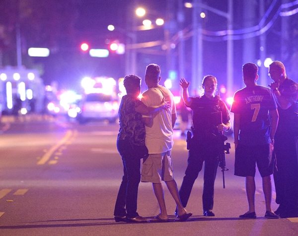 Orlando Police officers direct family members away from a multiple shooting at a nightclub in Orlando, Fla., Sunday, June 12, 2016. A gunman opened fire at a nightclub in central Florida, and multiple people have been wounded, police said Sunday. (AP Photo/Phelan M. Ebenhack)