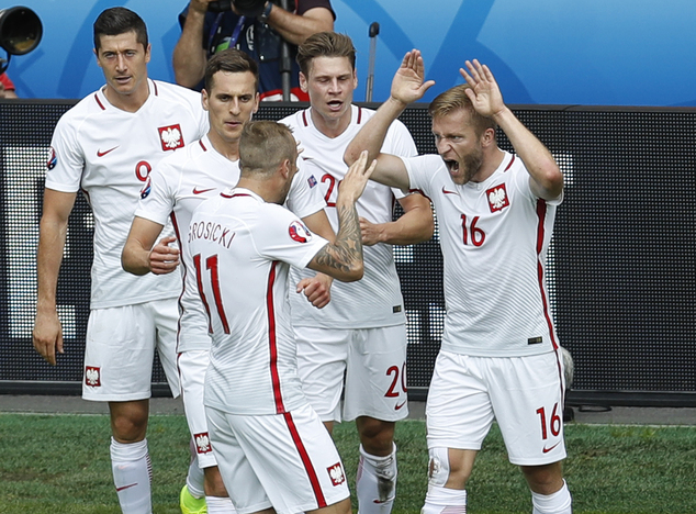 Poland's Jakub Blaszczykowski, right, celebrates with teammates after scoring during the Euro 2016 round