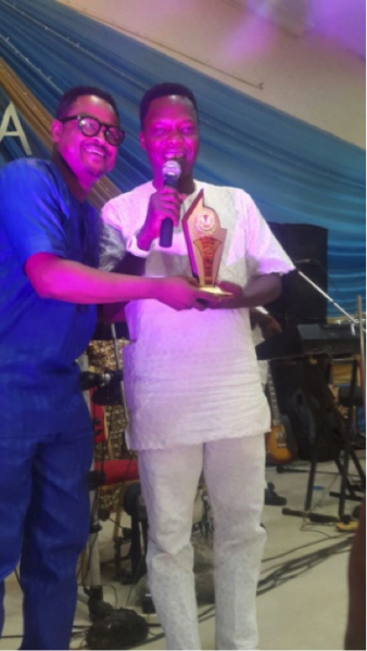 Mega 99 receiving his award.