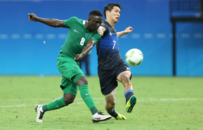 Nigeria's Oghenekaro Etebo strikes a shot against Japan. Credit: AP Photo/Michael Dantas