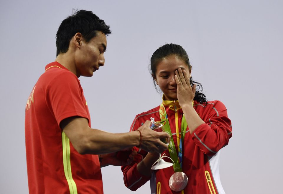 Silver medallist China's He Zi (R), reac