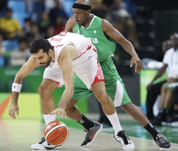 Croatia's Krunoslav Simon, left, picks up a loose ball in front of Nigeria's Josh Akognon during a basketball game at the 2016 Summer Olympics in Rio de Janeiro, Brazil, Saturday, Aug. 13, 2016. (AP Photo/Charlie Neibergall)