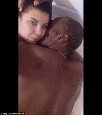 Half-clad Usain Bolt cuddles a pouting Jady Duarte