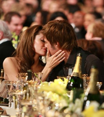 Brad Pitt and Angelina Jolie share a kiss.