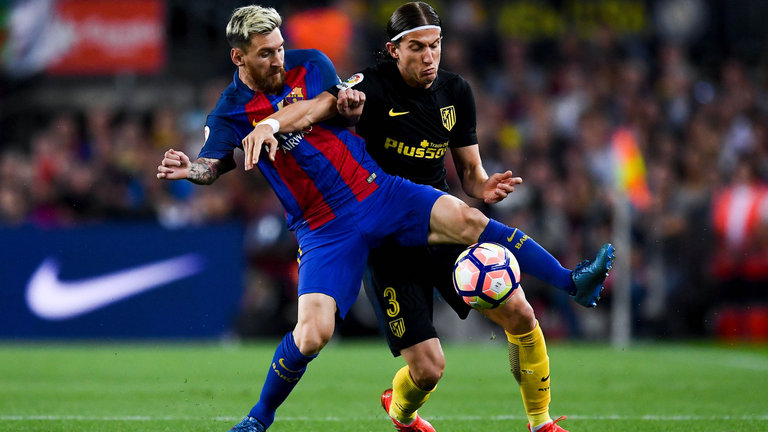 Lionel Messi battles with Filipe Luis at the Nou Camp in their 1-1 draw with Atletico Madrid. Credit: AP