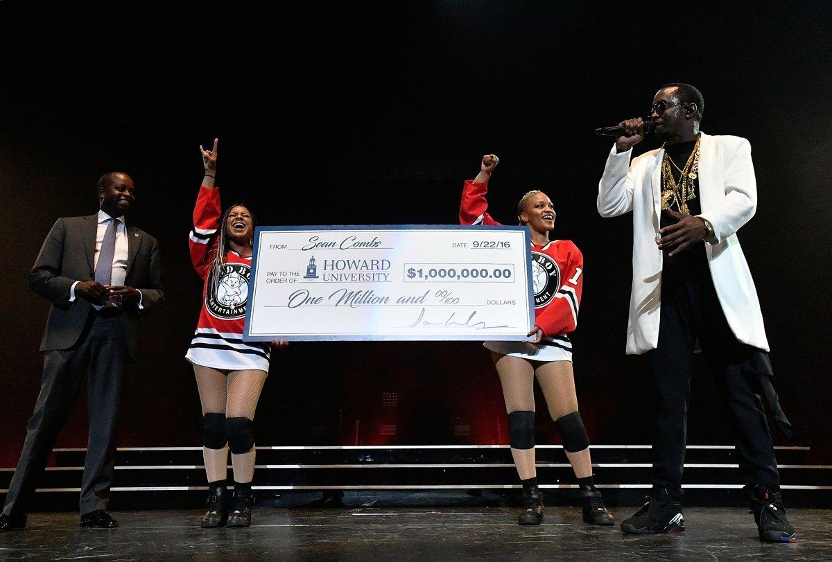 Diddy presents Howard University President Wayne Frederick with a check for $1 million at the Verizon Center in Washington, D.C. Photo: Getty